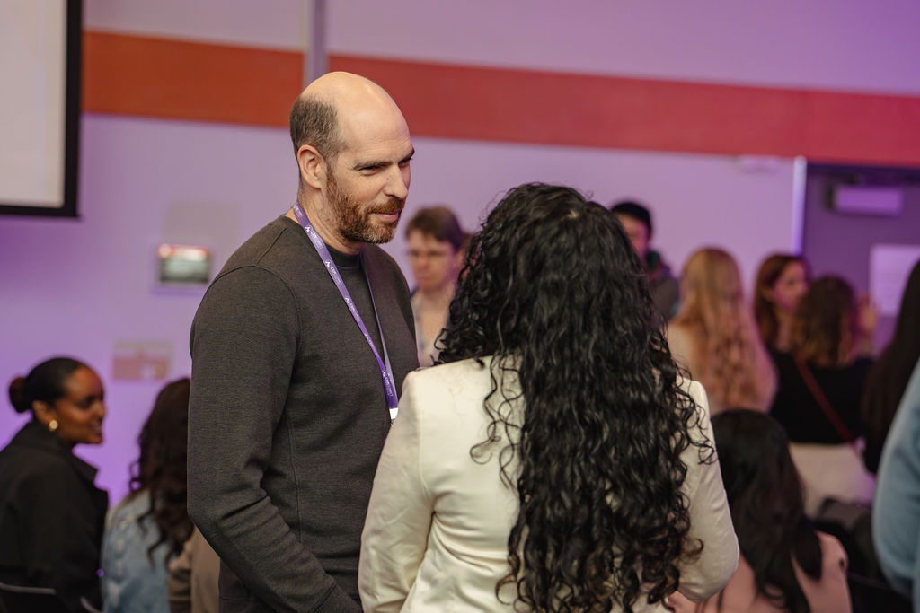 Two attendees talking together at a CDM Summit event