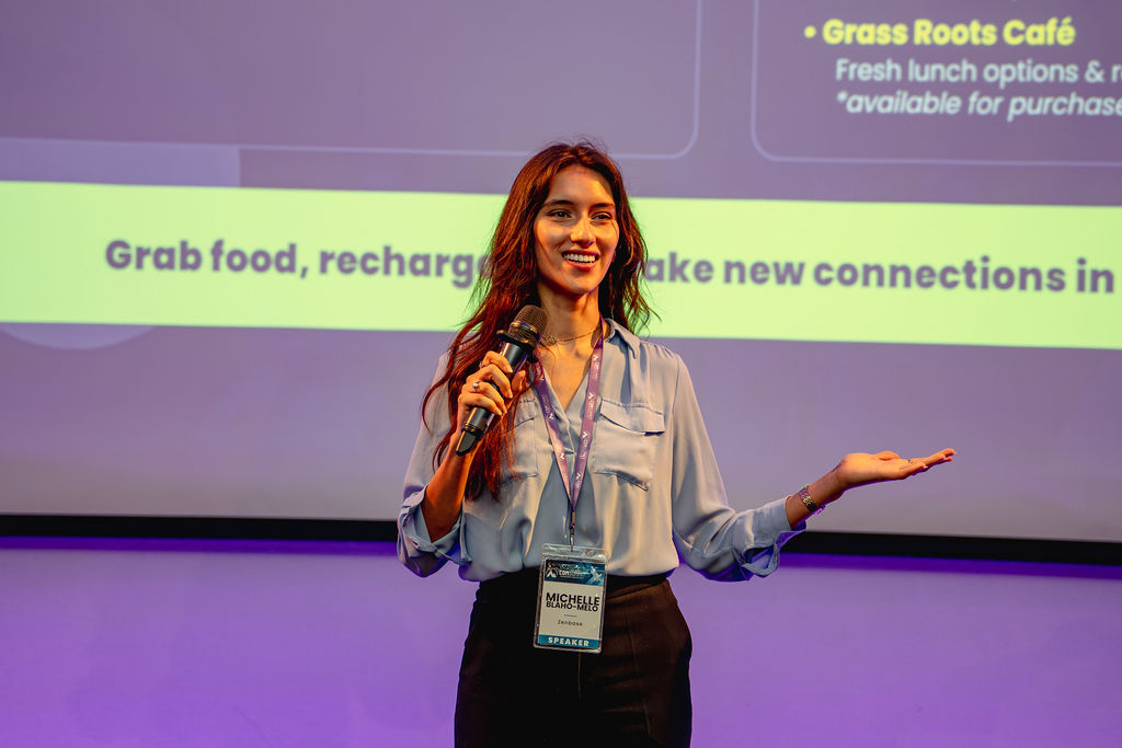 A speaker addressing the audience on stage